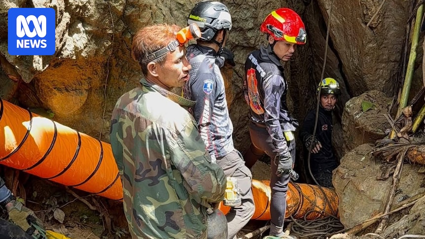 Rescuers race to reach seven people trapped in Laos cave after flash flooding