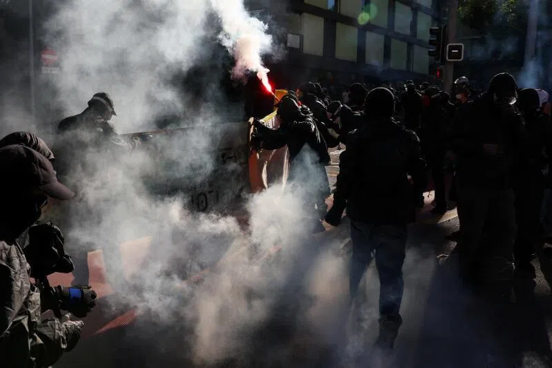 Protesters smash windows and set Tesla ablaze in anti-G-7 march in Geneva
