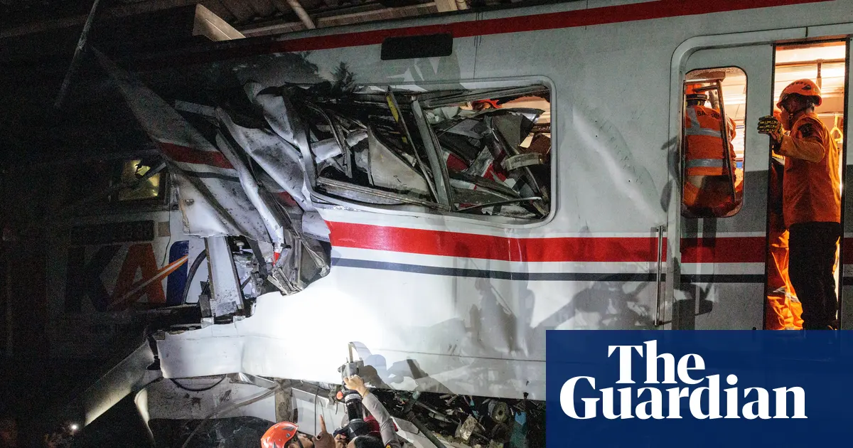 Train collision in Indonesia kills 14 as rescuers work to reach survivors