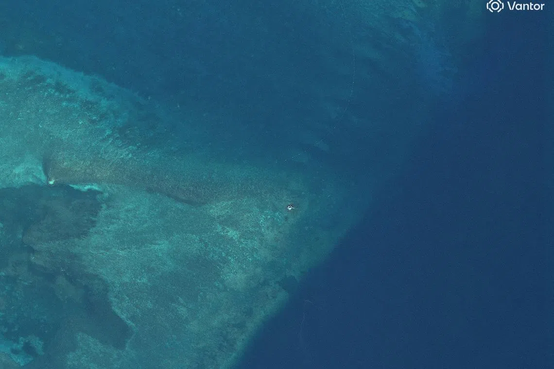 Satellite images show suspected structure at disputed South China Sea atoll, later removed