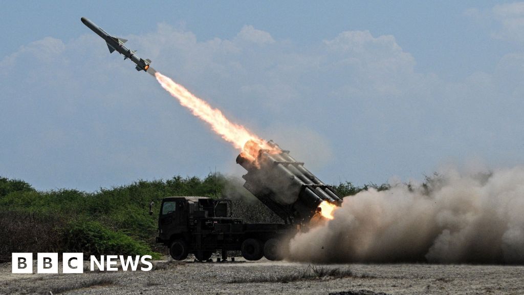 Japan defence minister denies militarism, criticises China's 'huge arsenal'