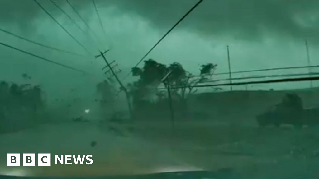 Dashcam captures tornado toppling power lines onto car