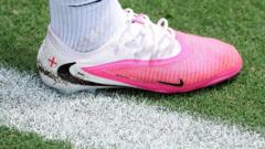 Why are footballers wearing pink boots at the World Cup?
