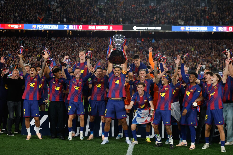 Watched by its grieving coach, Barcelona retains Spanish league title by beating rival Real Madrid