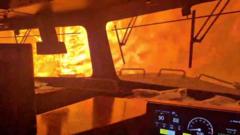 Dramatic video shows wildfire surround freight train in Canada