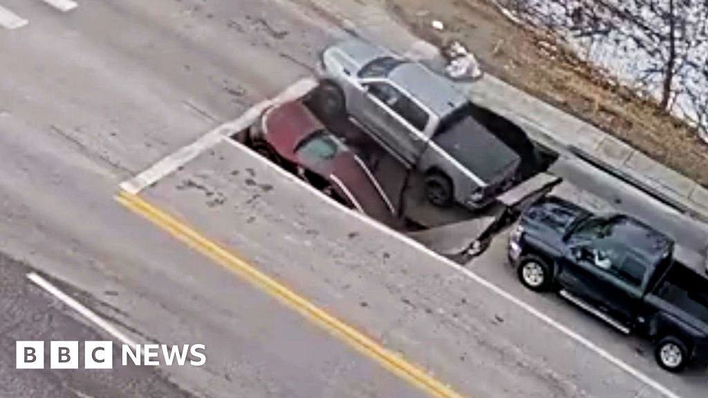 Watch: Moment a sinkhole in Omaha traps cars and drivers