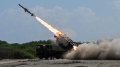Japan defence minister denies militarism, criticises China's 'huge arsenal'